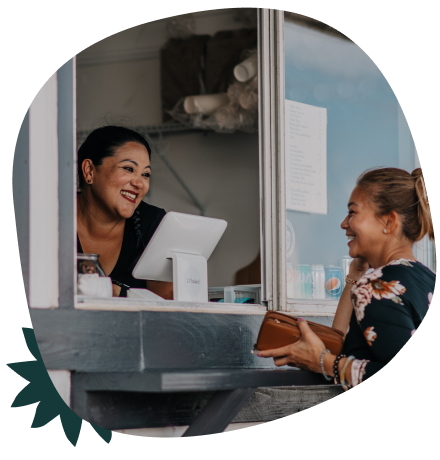 two woman chatting at a food truck
