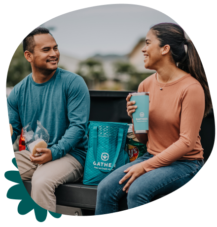 Young couple having lunch at back of truck