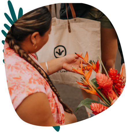 A woman shopping outdoors looking at florals