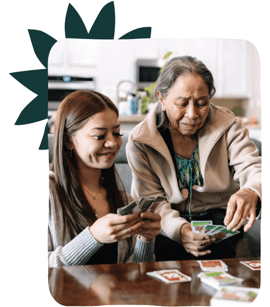 Girl and grandma playing cards