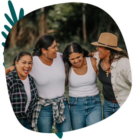 Four female friends laughing outside