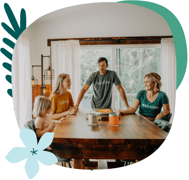 Family of four in kitchen at table