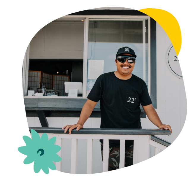 Local business owner smiling outside his building