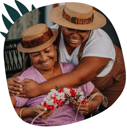Two woman embracing with florals in hand
