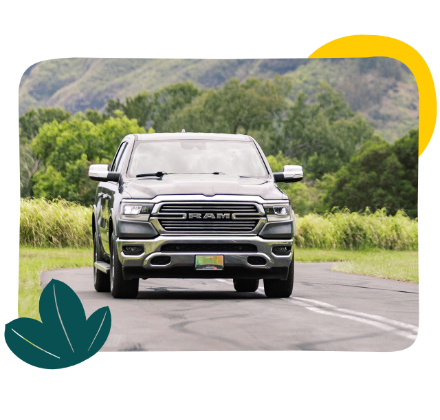 New RAM truck driving with beautiful kaui landscape in background